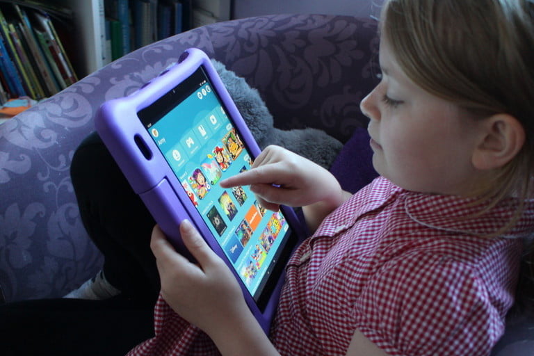 kid playing on tablet